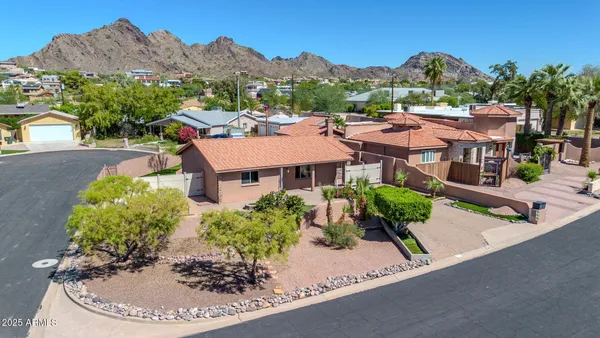 an aerial view of a house with a yard