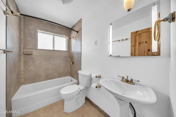 a bathroom with a toilet a sink and bathtub
