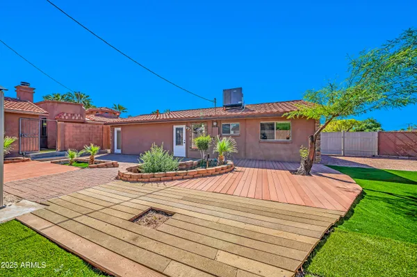 a street view with wooden fence and potted plants