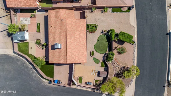 an aerial view of residential houses with outdoor space and parking