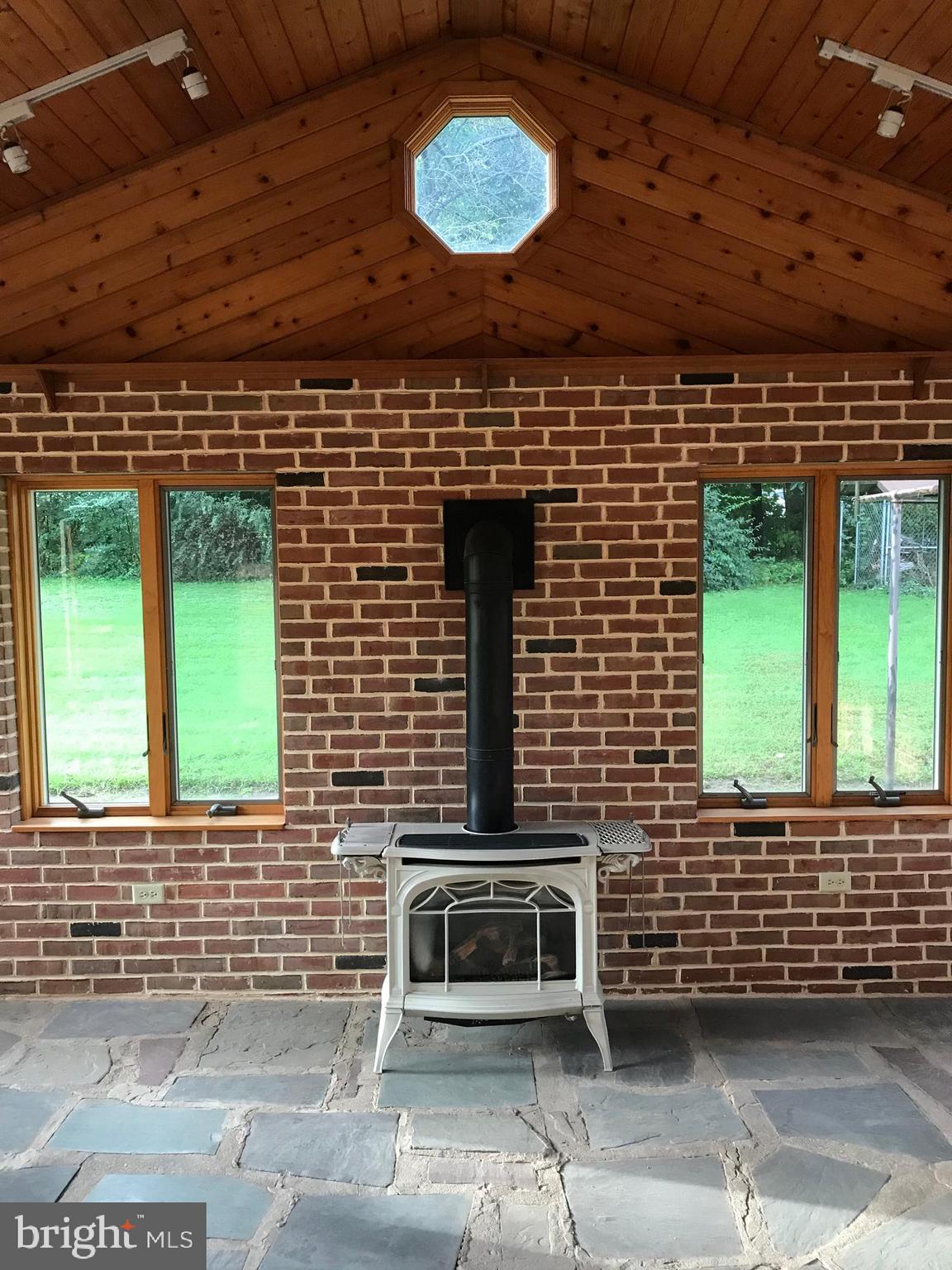 1870 Church Road York, PA 17408 - Photo 34 of 35 Gas burning fireplace in sunroom.