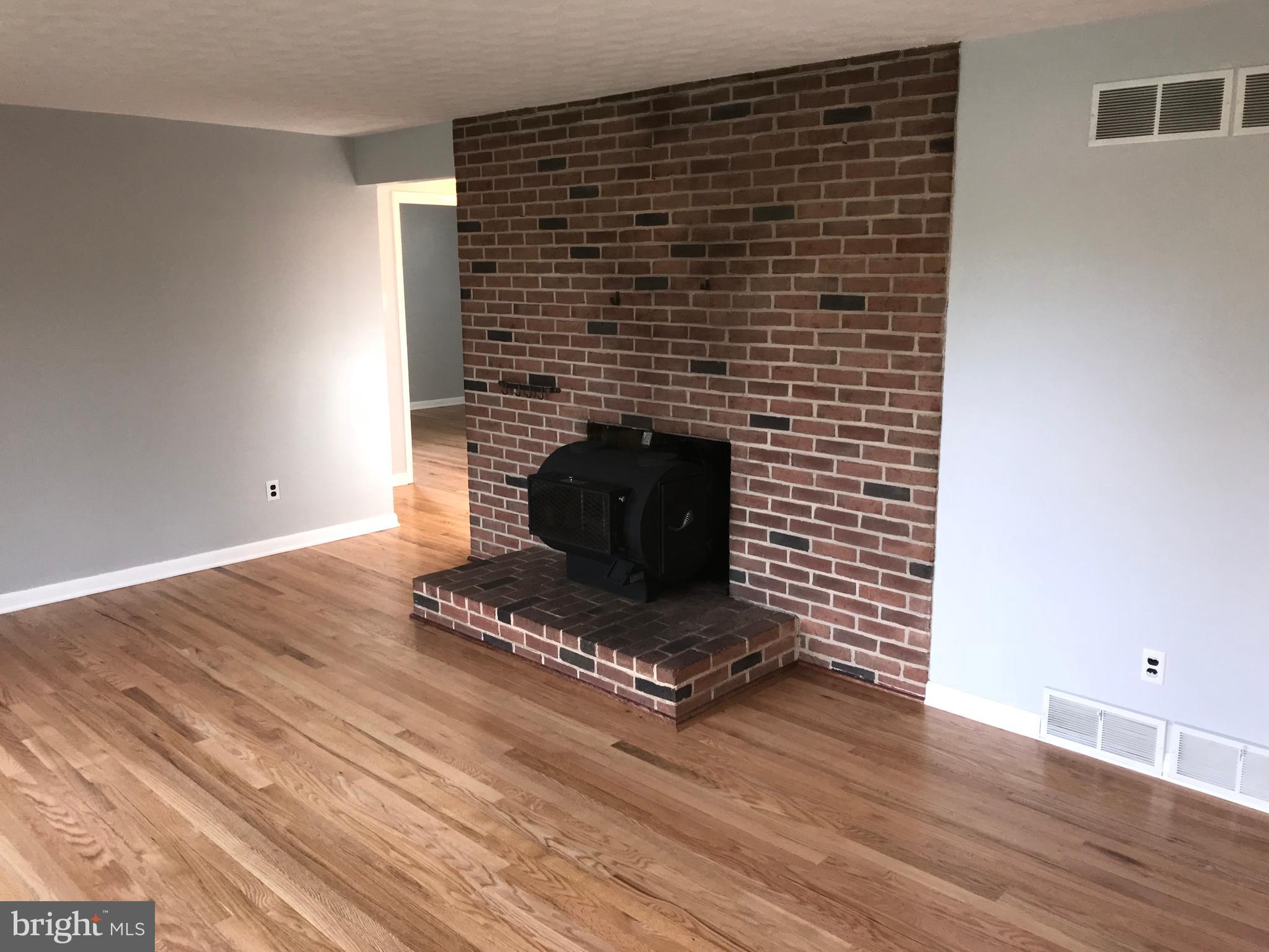 1870 Church Road York, PA 17408 - Photo 9 of 35 Gleaming hardwood flooring and wood stove.