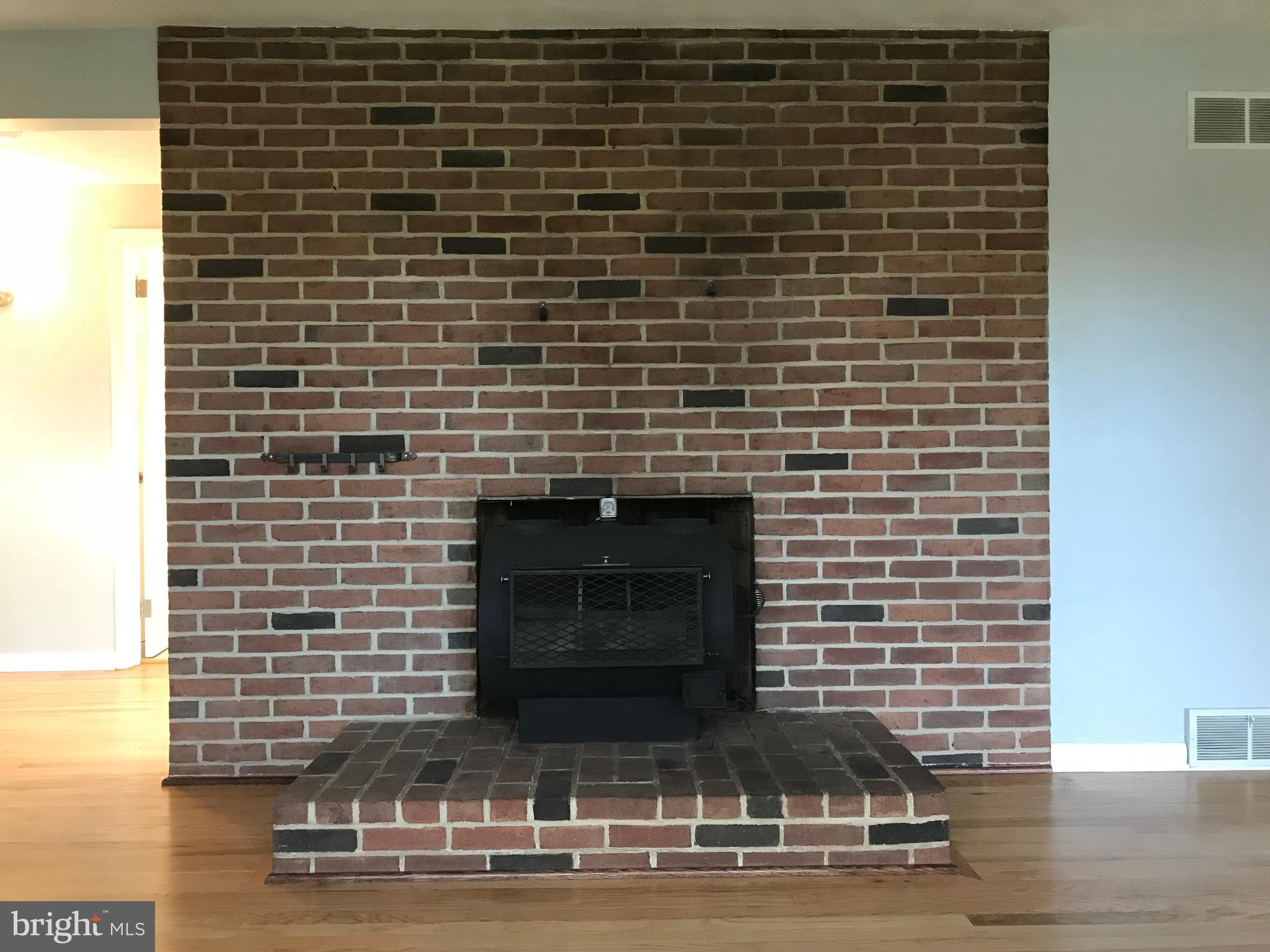 1870 Church Road York, PA 17408 - Photo 10 of 35 Brick fireplace with wood burning stove.