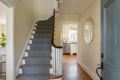 a view of entryway with wooden floor and glass door