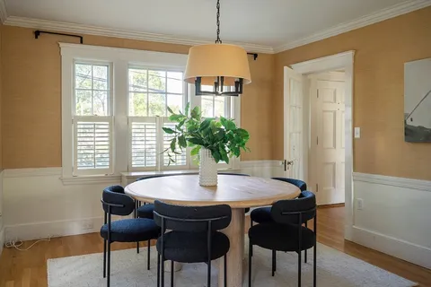 a dining room with furniture and window