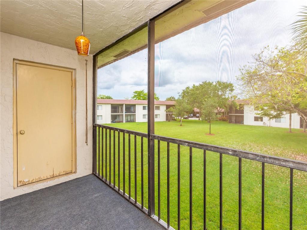 16243 Saddle Club Road, Unit 204 Weston, FL 33326 - Photo 25 of 48 a view of a porch with a floor to ceiling window next to a yard