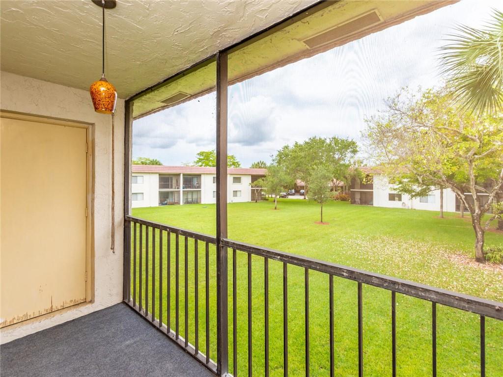 16243 Saddle Club Road, Unit 204 Weston, FL 33326 - Photo 28 of 48 a view of a porch with a floor to ceiling window next to a yard