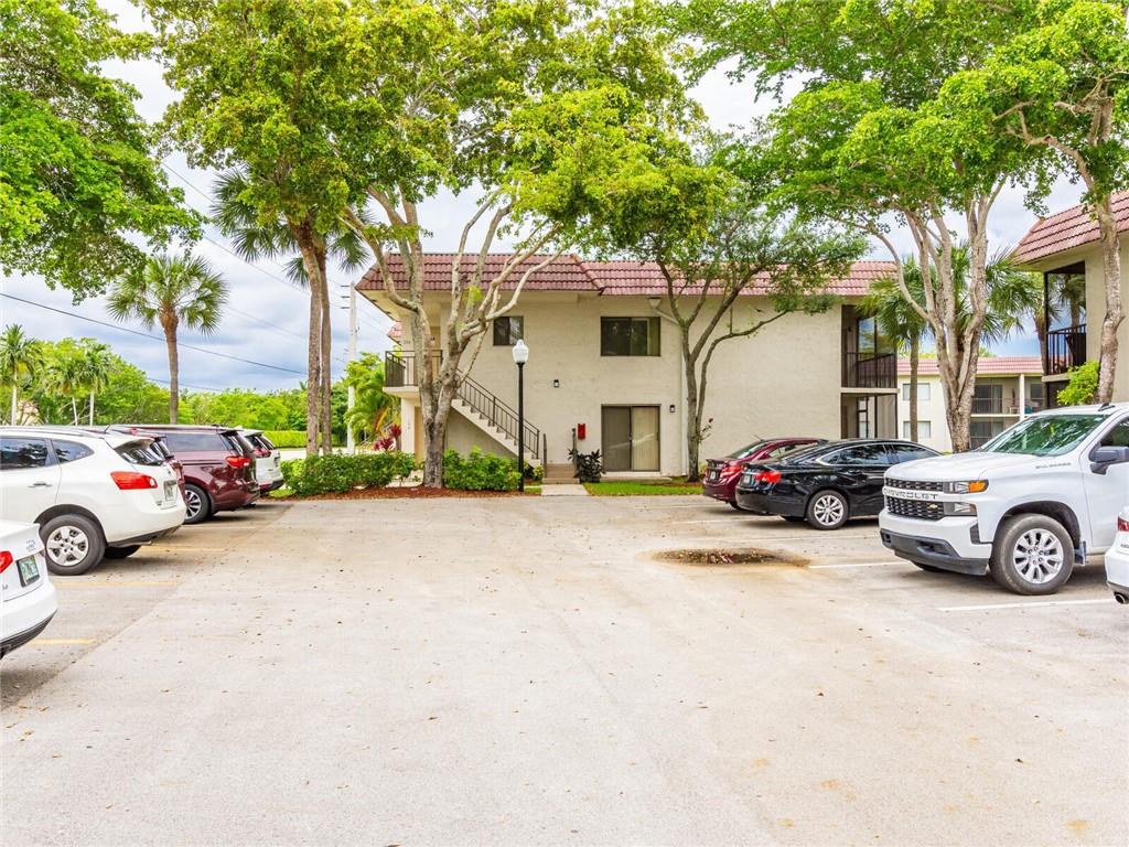 16243 Saddle Club Road, Unit 204 Weston, FL 33326 - Photo 45 of 48 a view of a cars parked in front of a house