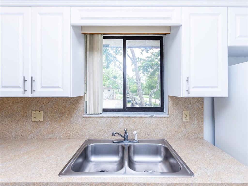 16243 Saddle Club Road, Unit 204 Weston, FL 33326 - Photo 6 of 48 a kitchen with a sink a window and cabinets