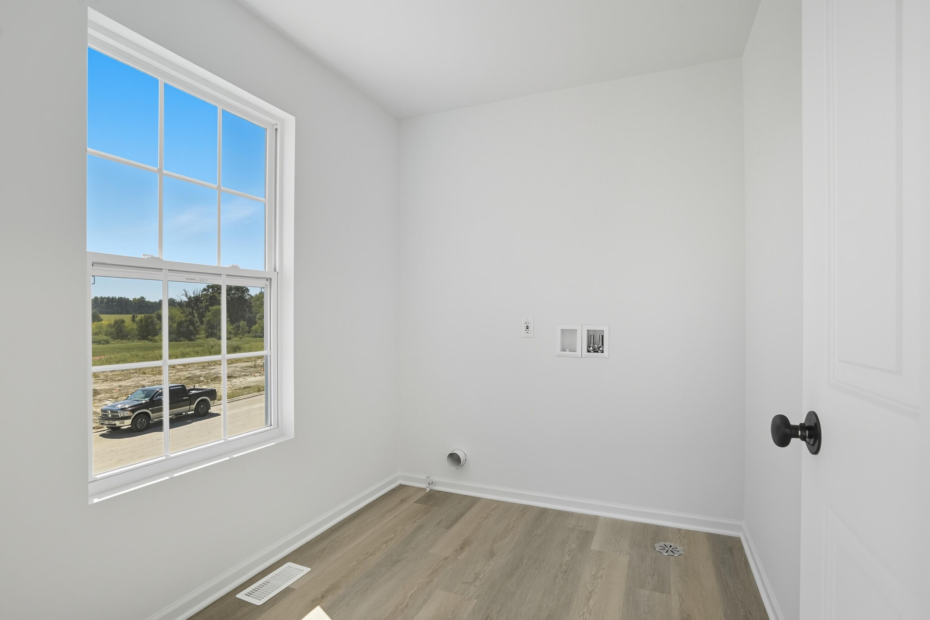 6866 East 104th Avenue Crown Point, IN 46307 - Photo 16 of 16 a view of a room with wooden floor and windows