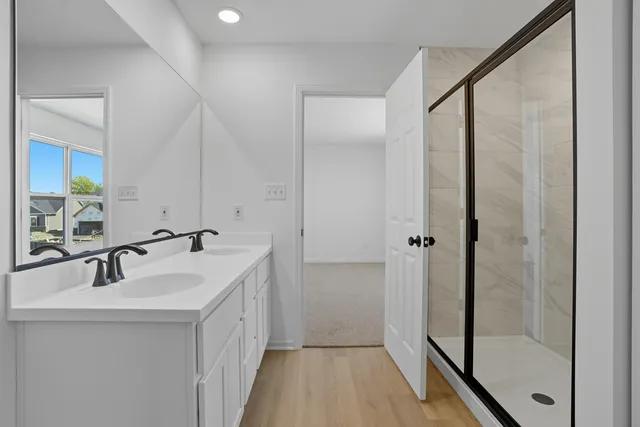 a bathroom with a double vanity sink and mirror
