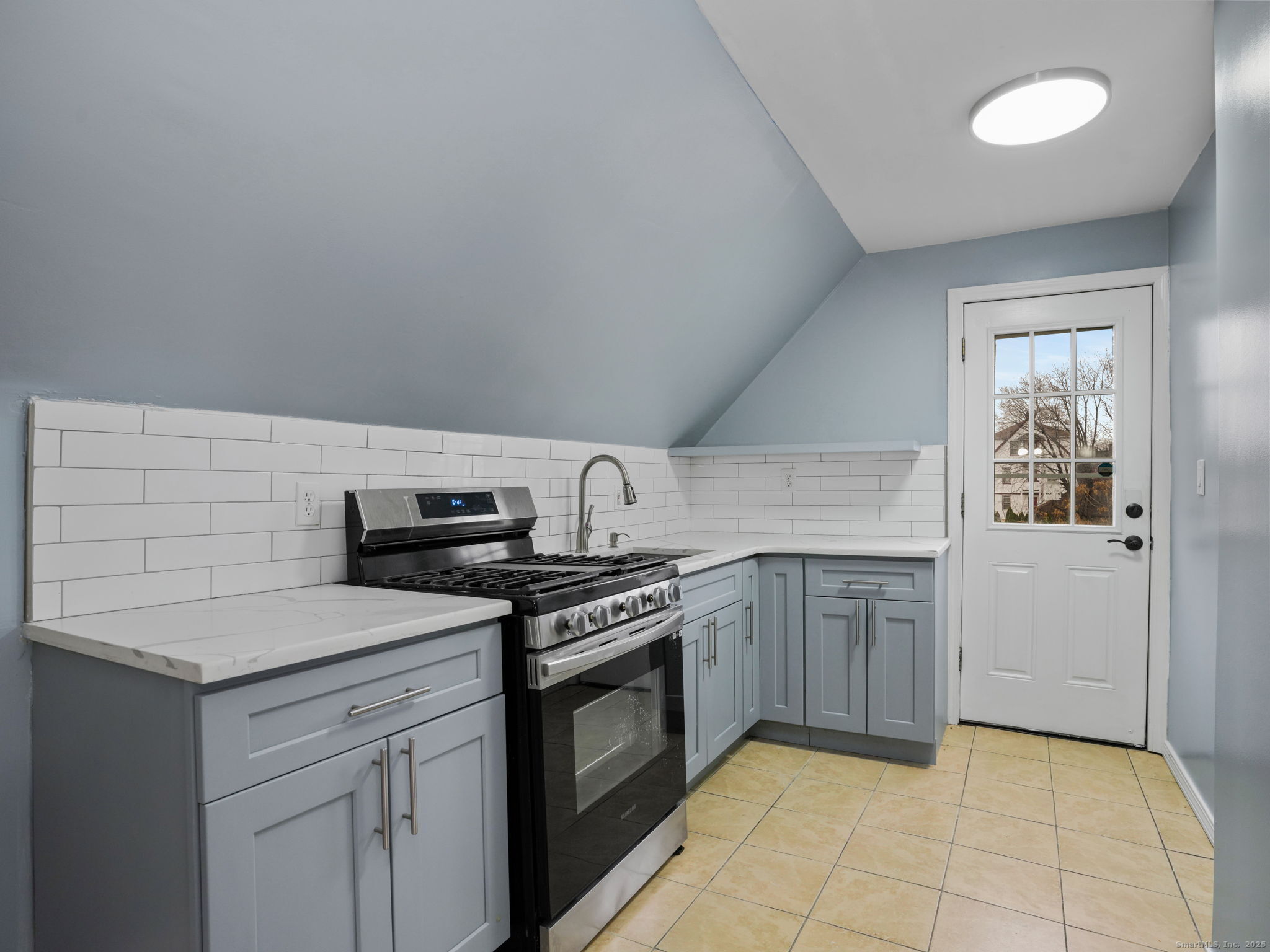 90 Amsterdam Avenue, Unit 2 Bridgeport, CT 06606 - Photo 5 of 10 a kitchen with a stove sink and cabinets