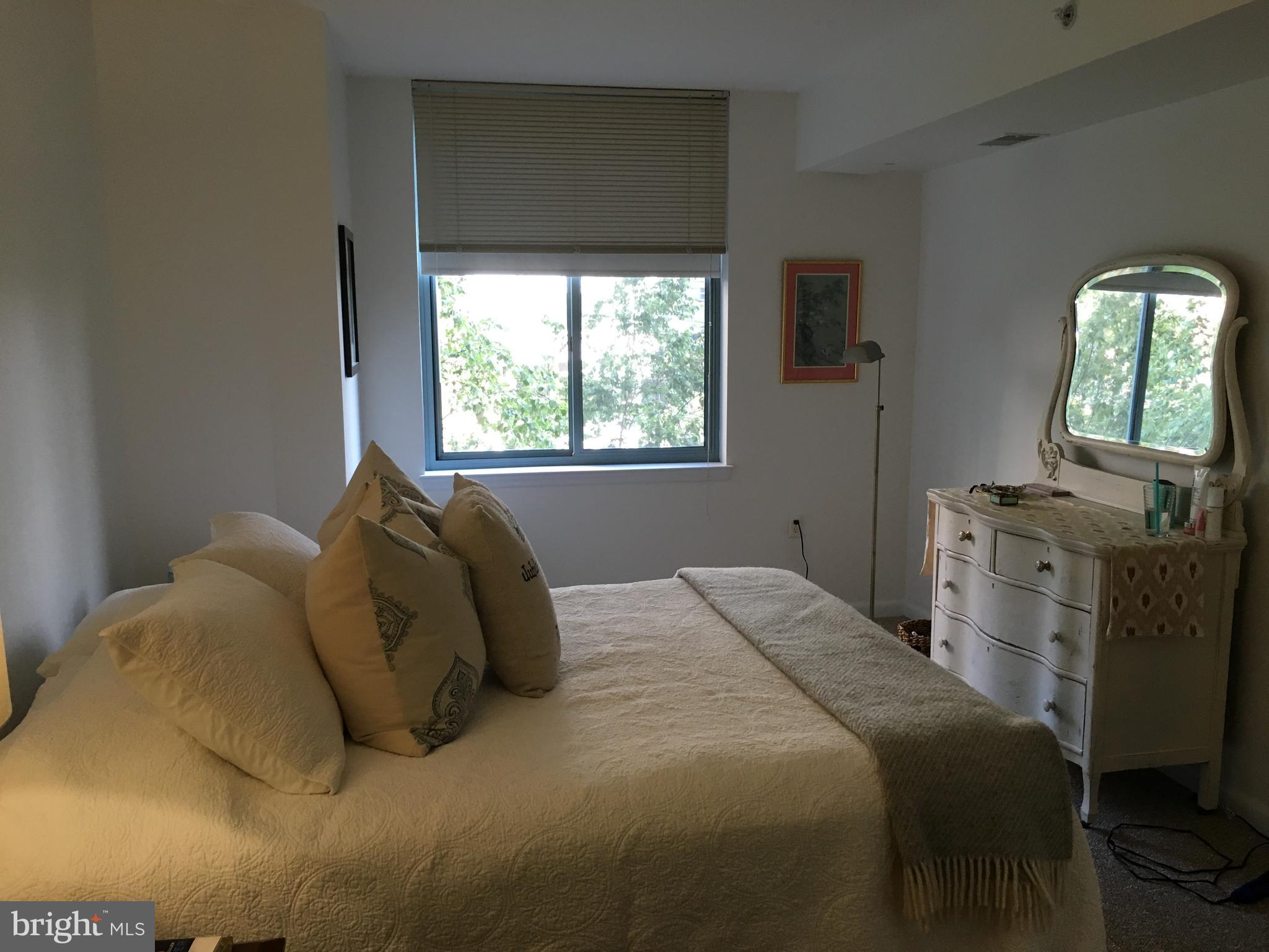 851 North Glebe Road, Unit 419 Arlington, VA 22203 - Photo 12 of 19 a bed sitting in a bedroom next to a window