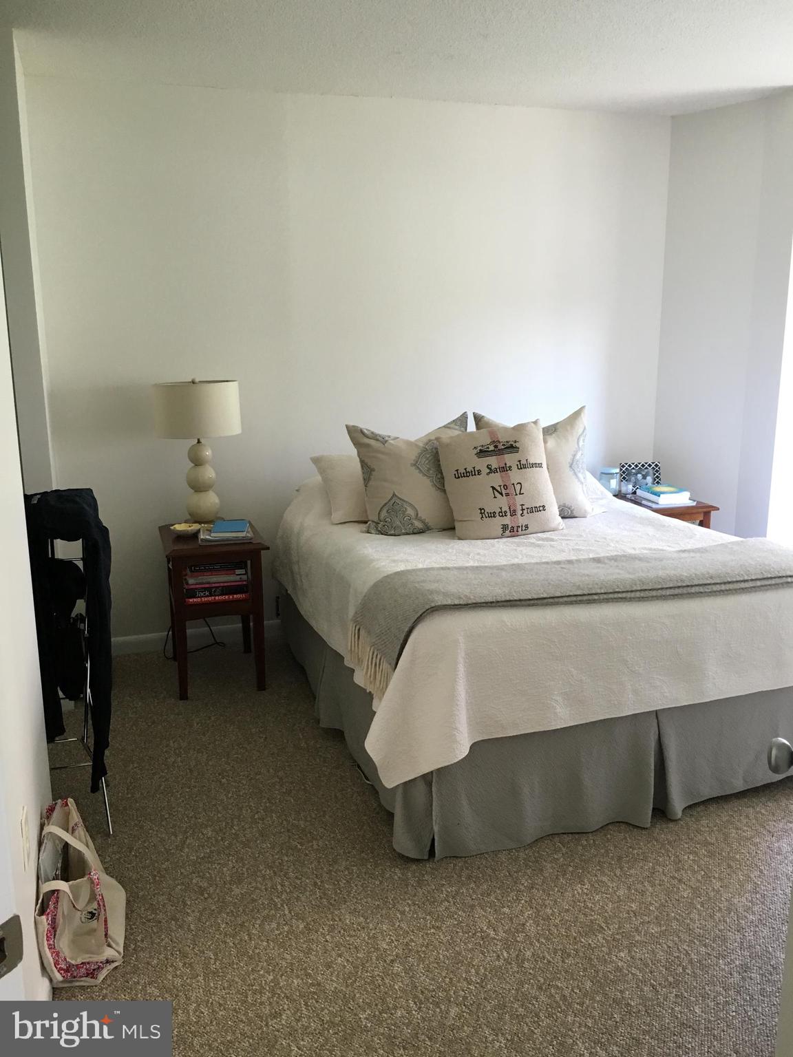 851 North Glebe Road, Unit 419 Arlington, VA 22203 - Photo 13 of 19 a bedroom with a bed and a chair in it