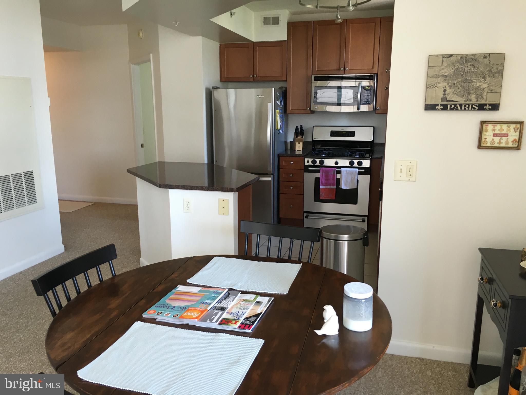 851 North Glebe Road, Unit 419 Arlington, VA 22203 - Photo 6 of 19 a kitchen with stainless steel appliances granite countertop a refrigerator stove and a sink