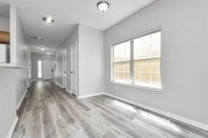 wooden floor in an empty room with a window