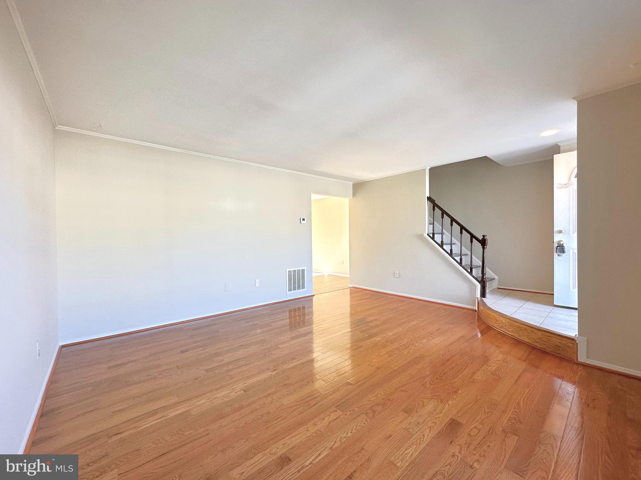 402 Carousel Court Gaithersburg, MD 20877 - Photo 6 of 29 a view of an empty room with wooden floor