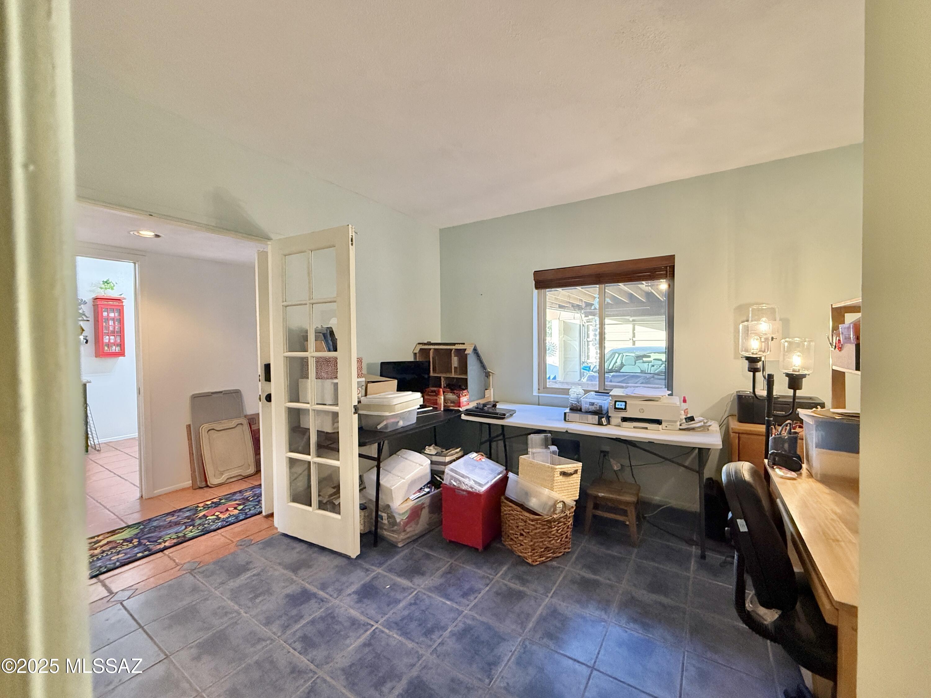 8110 East Rivenoak Circle Tucson, AZ 85715 - Photo 13 of 29 a work room with furniture a large window and rug