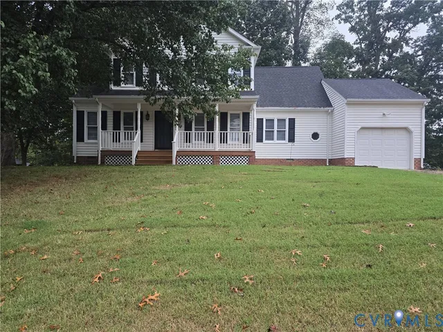 a front view of a house with a garden and trees