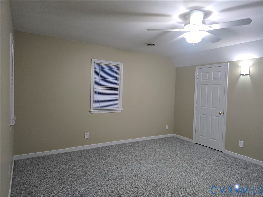 14300 Michaux View Way Midlothian, VA 23113 - Photo 20 of 29 an empty room with a chandelier fan and windows