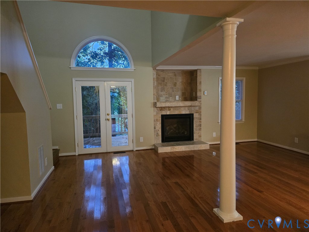 14300 Michaux View Way Midlothian, VA 23113 - Photo 3 of 29 an empty room with wooden floor fireplace and windows