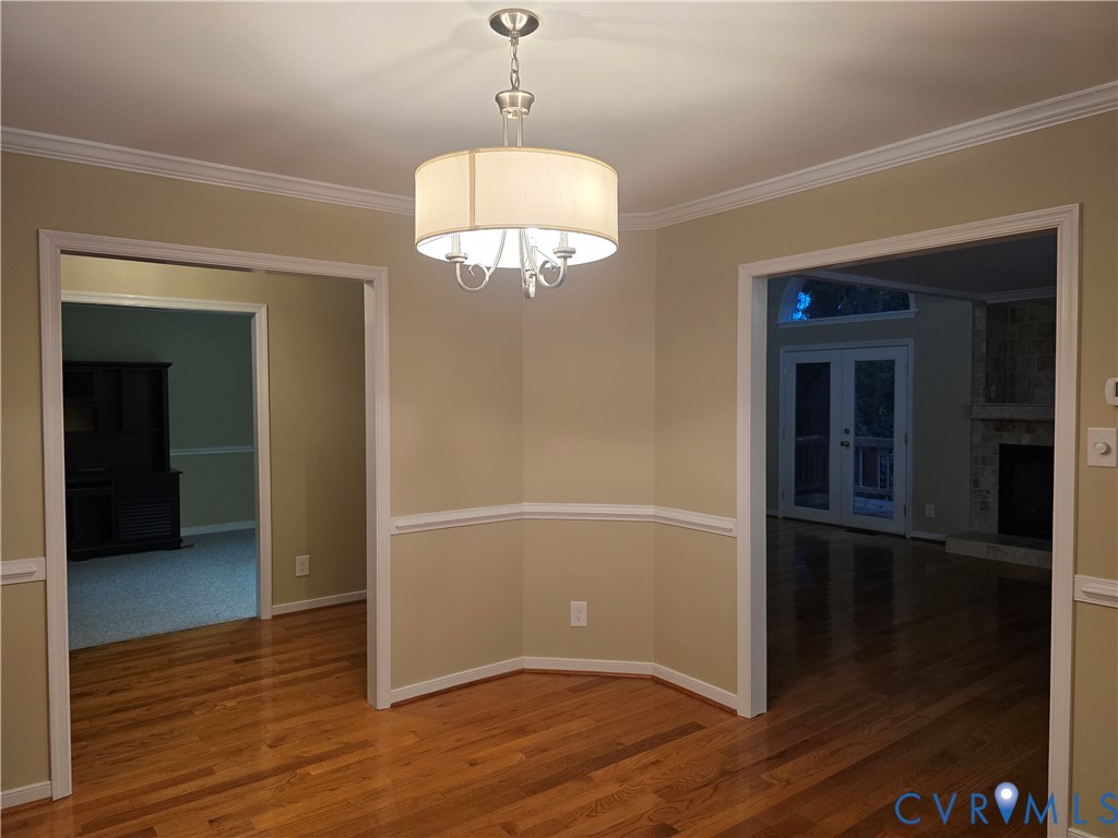 14300 Michaux View Way Midlothian, VA 23113 - Photo 9 of 29 an empty room with wooden floor chandelier and windows