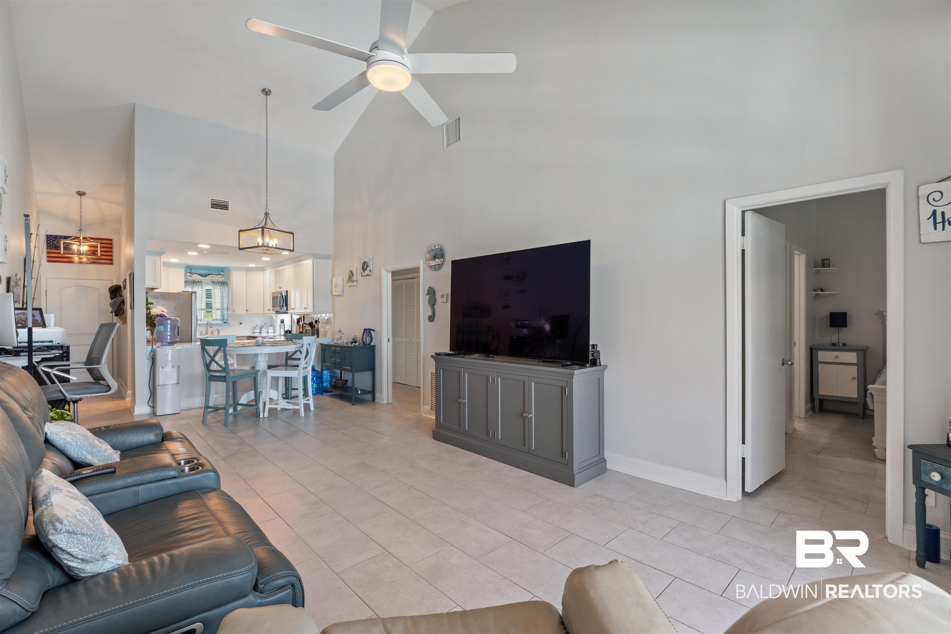 14100 River Road, Unit 327B Perdido Key, FL 32507 - Photo 16 of 46 Living room featuring high vaulted ceiling, ceiling fan, and light tile patterned floors