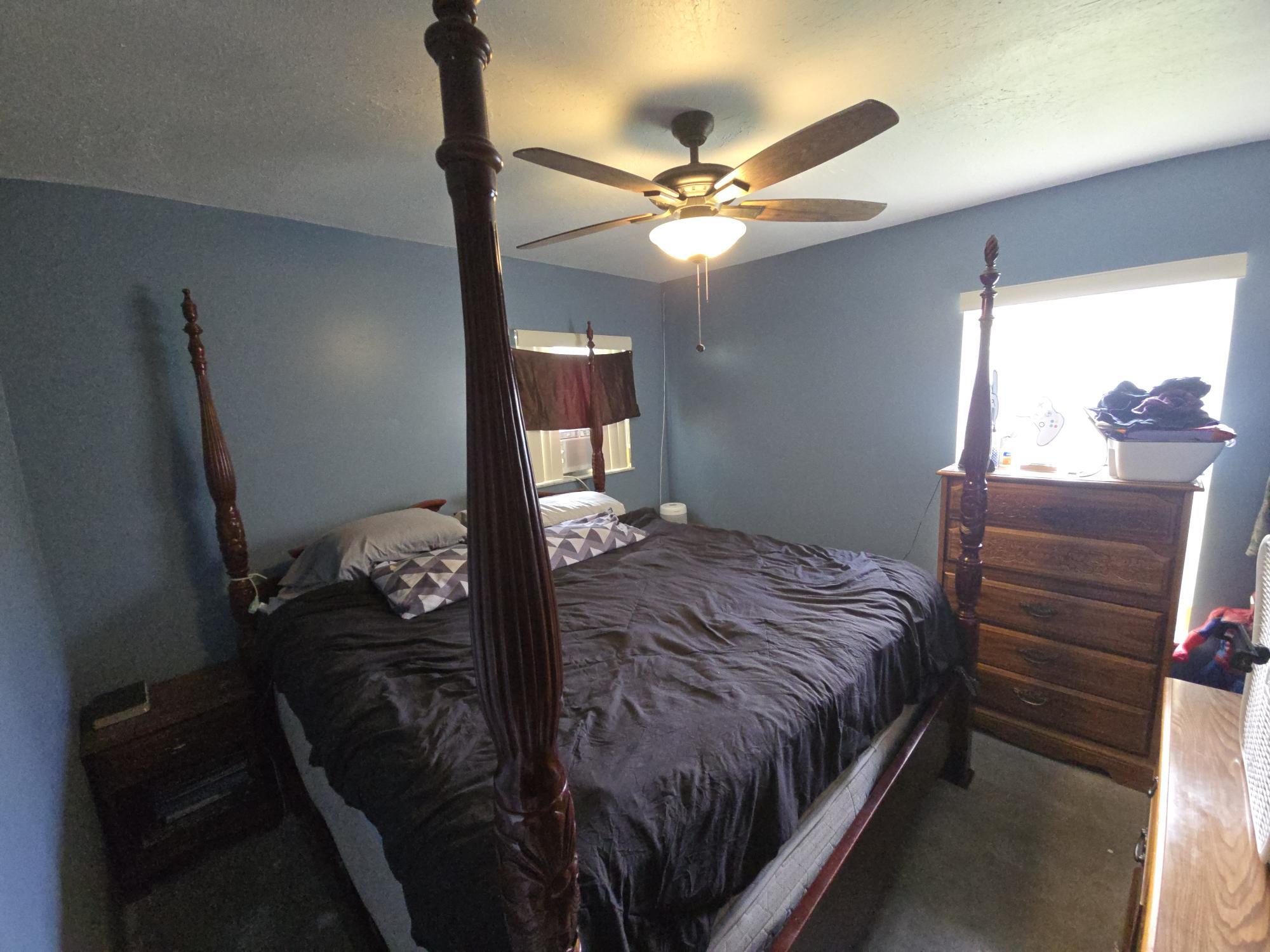 1346 23rd Avenue Southwest Vero Beach, FL 32962 - Photo 13 of 31 a bedroom with a bed and a chandelier