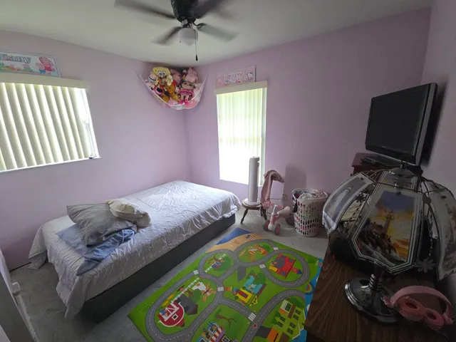 a bedroom with a bed and a window