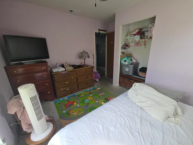 a bedroom with a bed and furniture