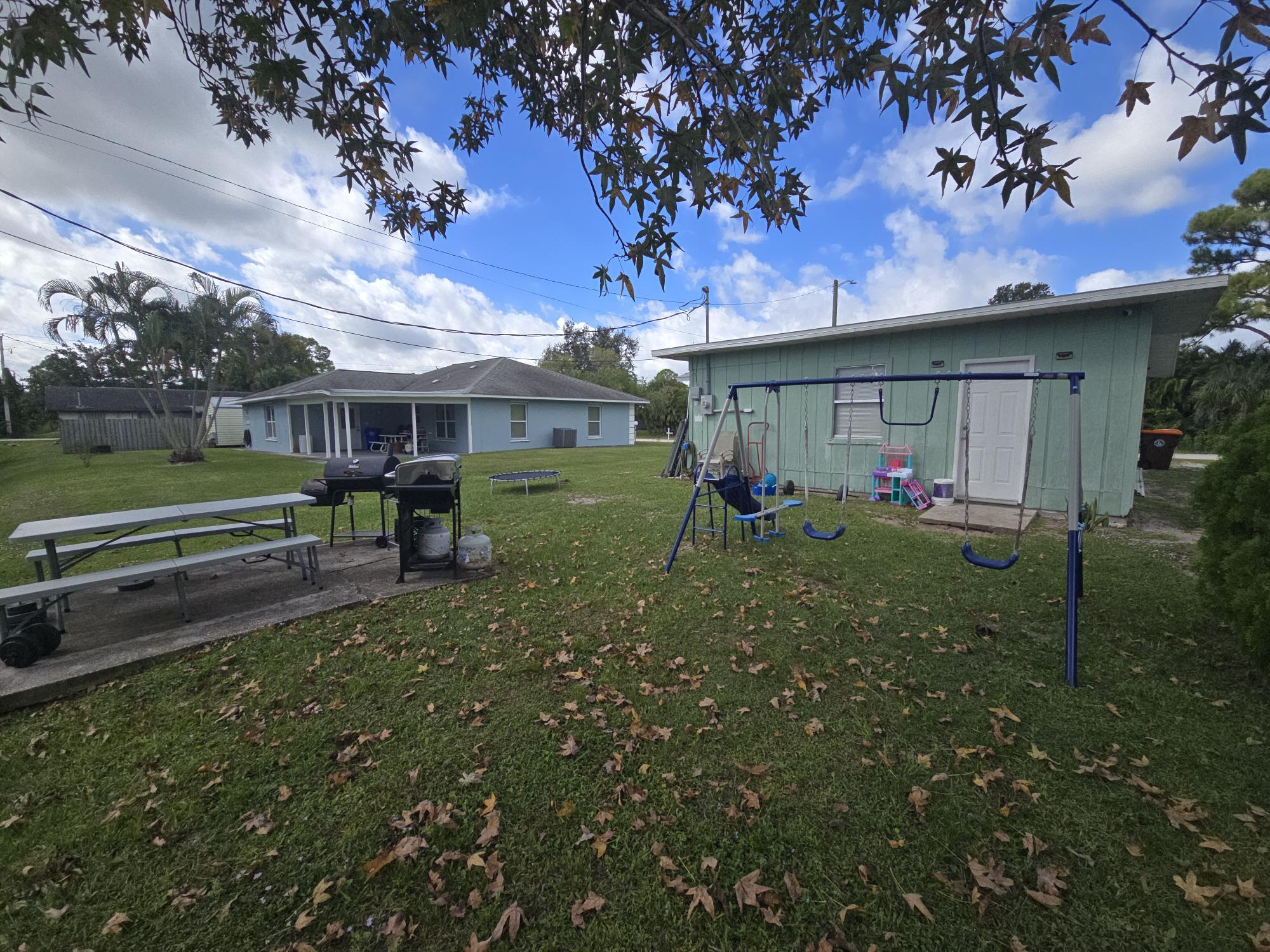 1346 23rd Avenue Southwest Vero Beach, FL 32962 - Photo 26 of 31 a view of a house with a back yard