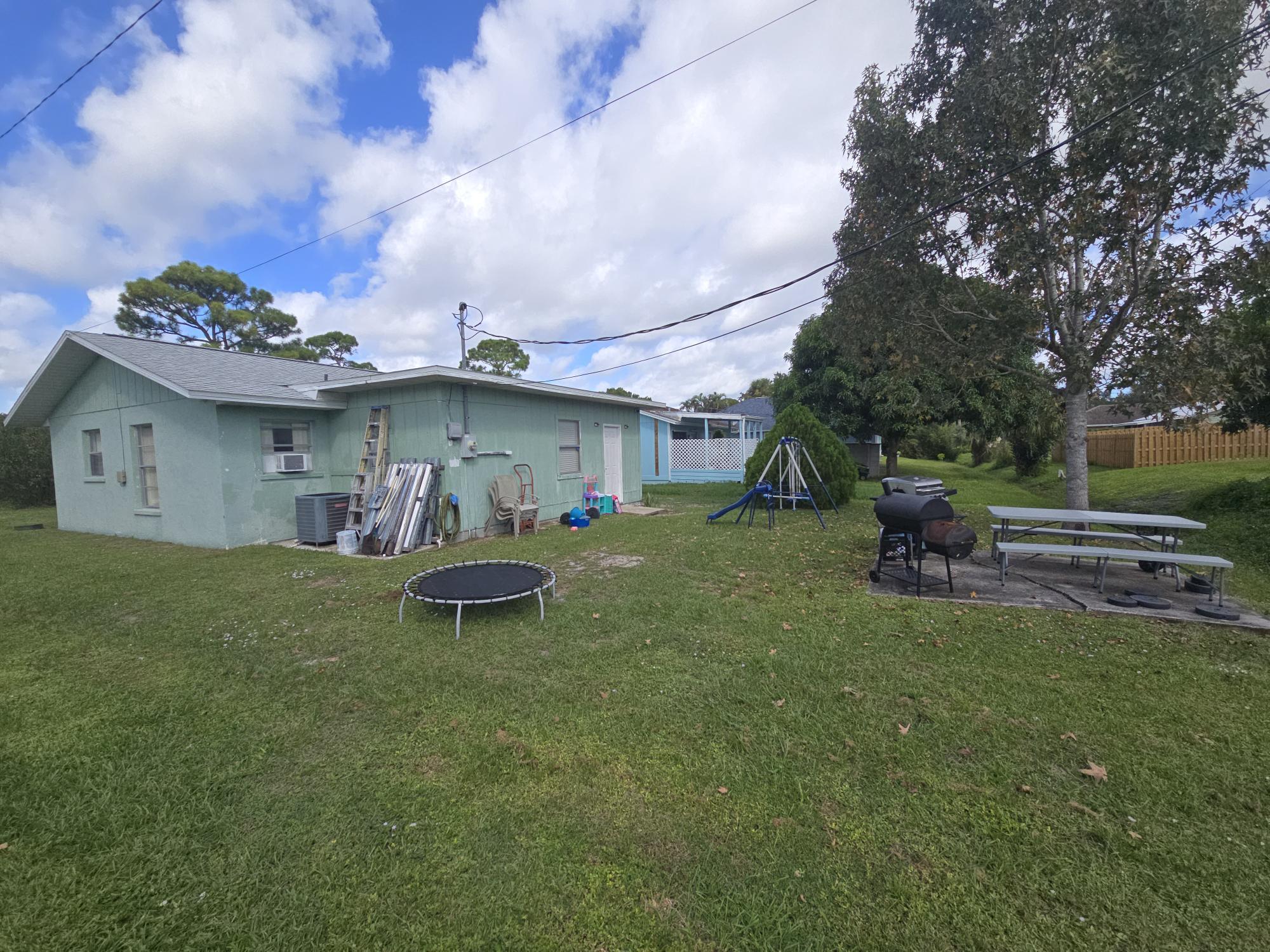 1346 23rd Avenue Southwest Vero Beach, FL 32962 - Photo 27 of 31 a front view of a house with garden and a yard