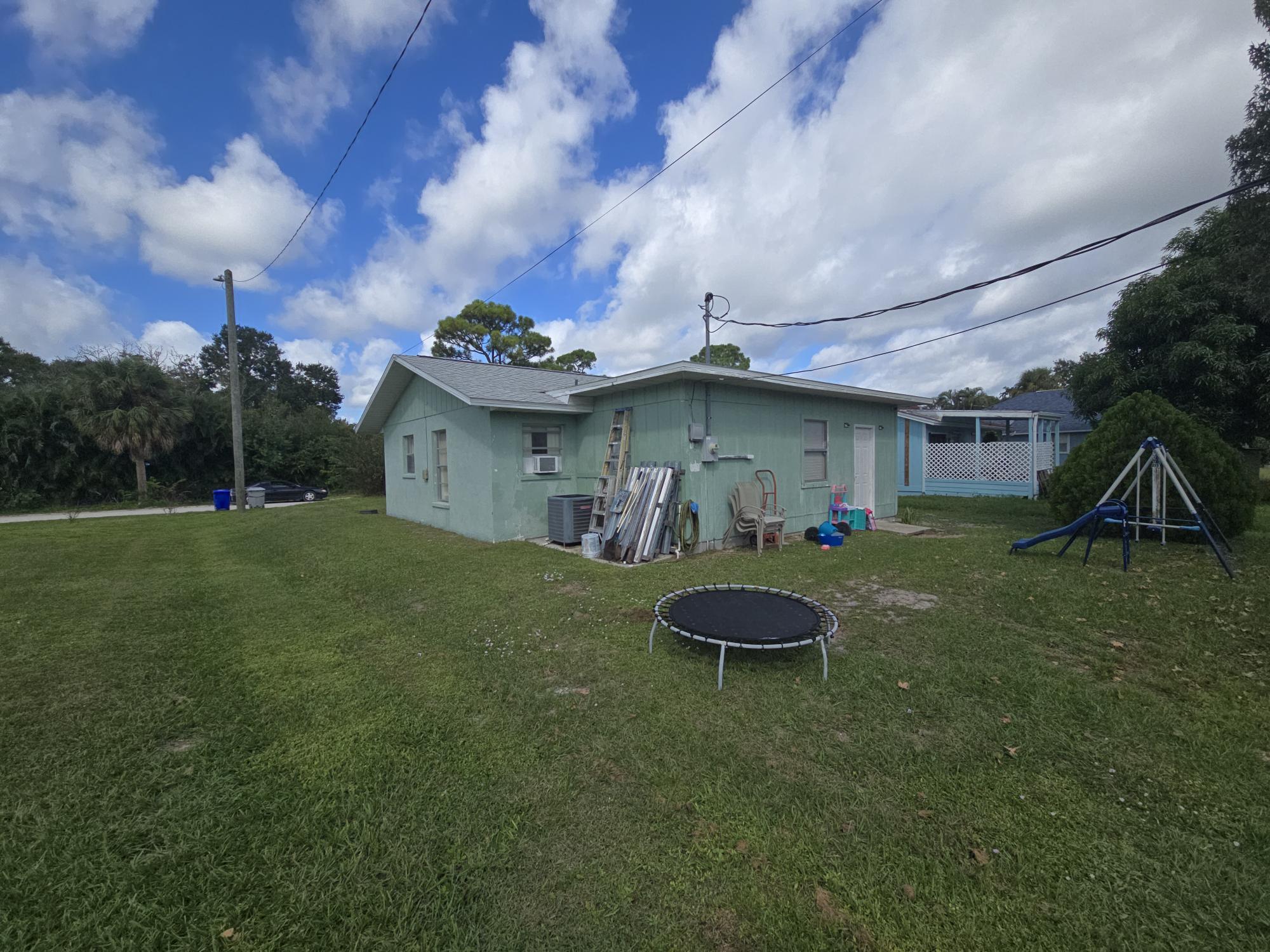 1346 23rd Avenue Southwest Vero Beach, FL 32962 - Photo 28 of 31 a front view of a house with garden