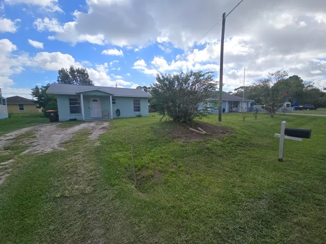 a view of a house with a backyard