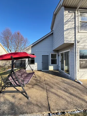 a view of a house with backyard and sitting area
