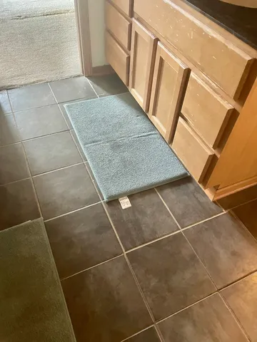 a view of a bedroom with a ceiling fan and a window