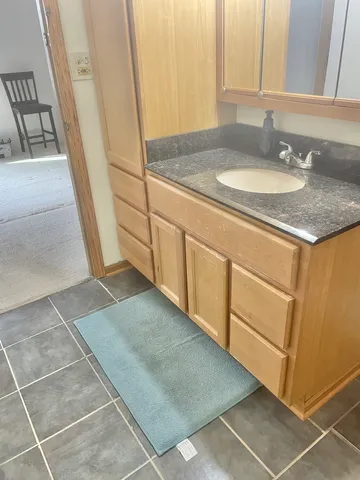 a view of a yard with wooden fence