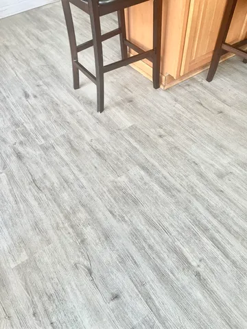 a kitchen with kitchen island granite countertop a stove top oven a sink a counter space and cabinets