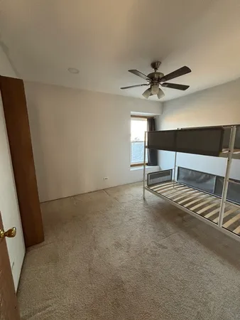 a living room with furniture and a ceiling fan