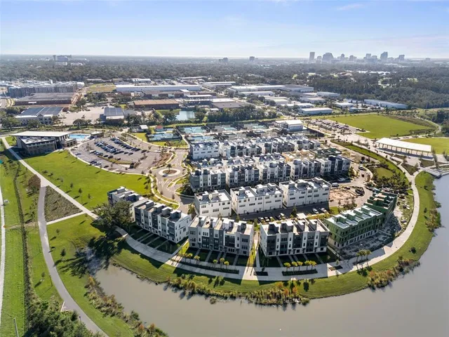 an aerial view of a house with a swimming pool outdoor space and seating space