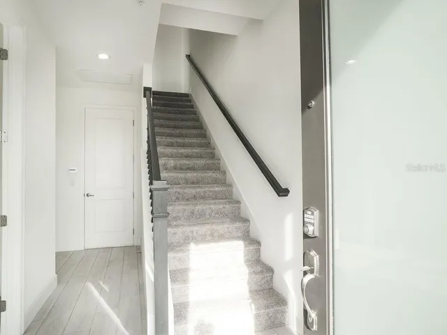 a view of entryway and hall with wooden floor