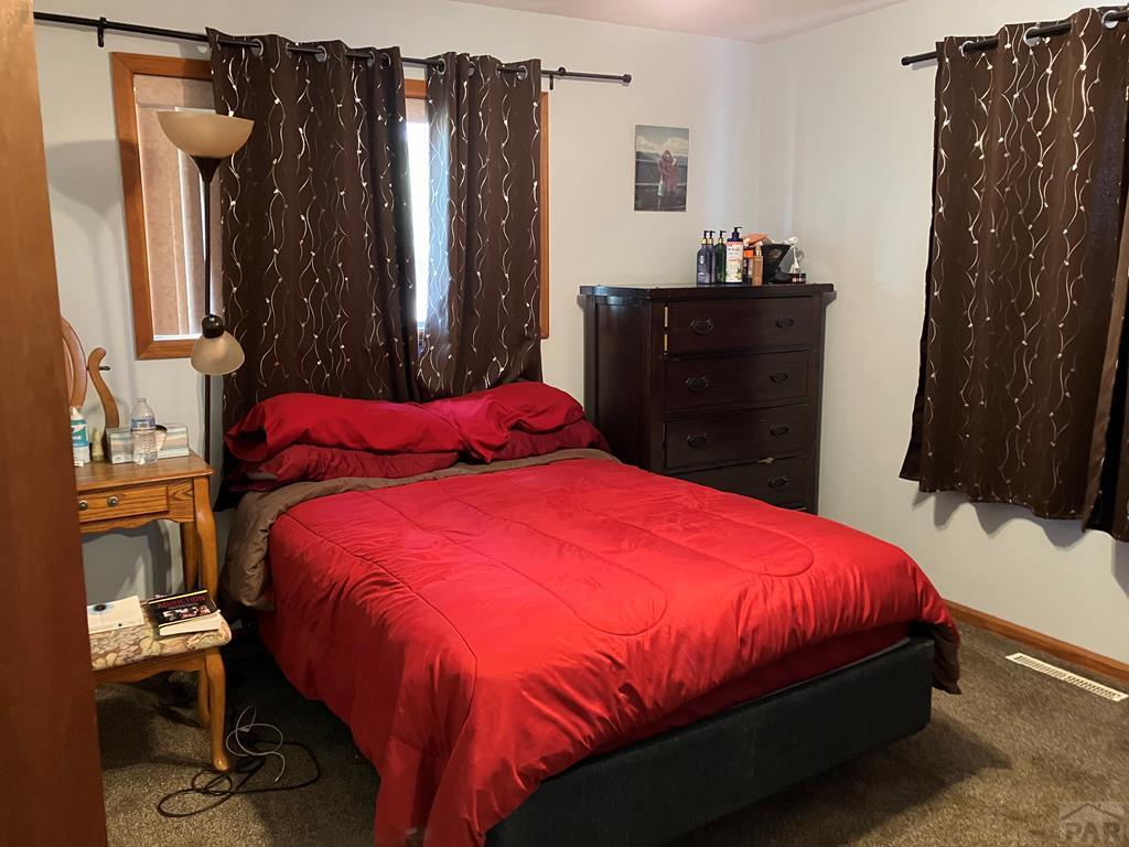 915 Maple Avenue La Junta, CO 81050 - Photo 12 of 34 a bedroom with a bed and a closet
