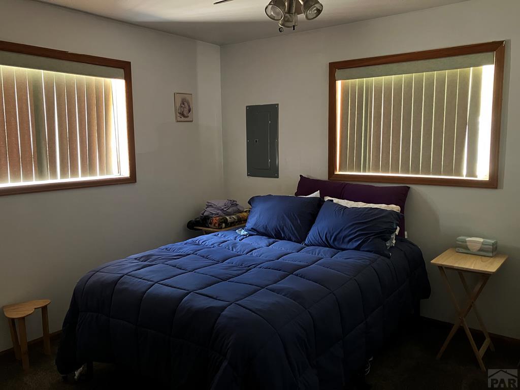 915 Maple Avenue La Junta, CO 81050 - Photo 16 of 34 a bed sitting in a bedroom next to a window
