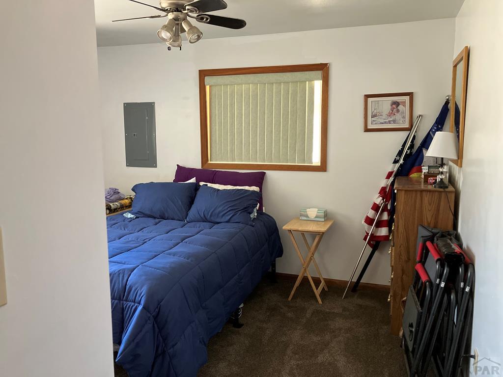 915 Maple Avenue La Junta, CO 81050 - Photo 17 of 34 a bed room with a bed and a chandelier