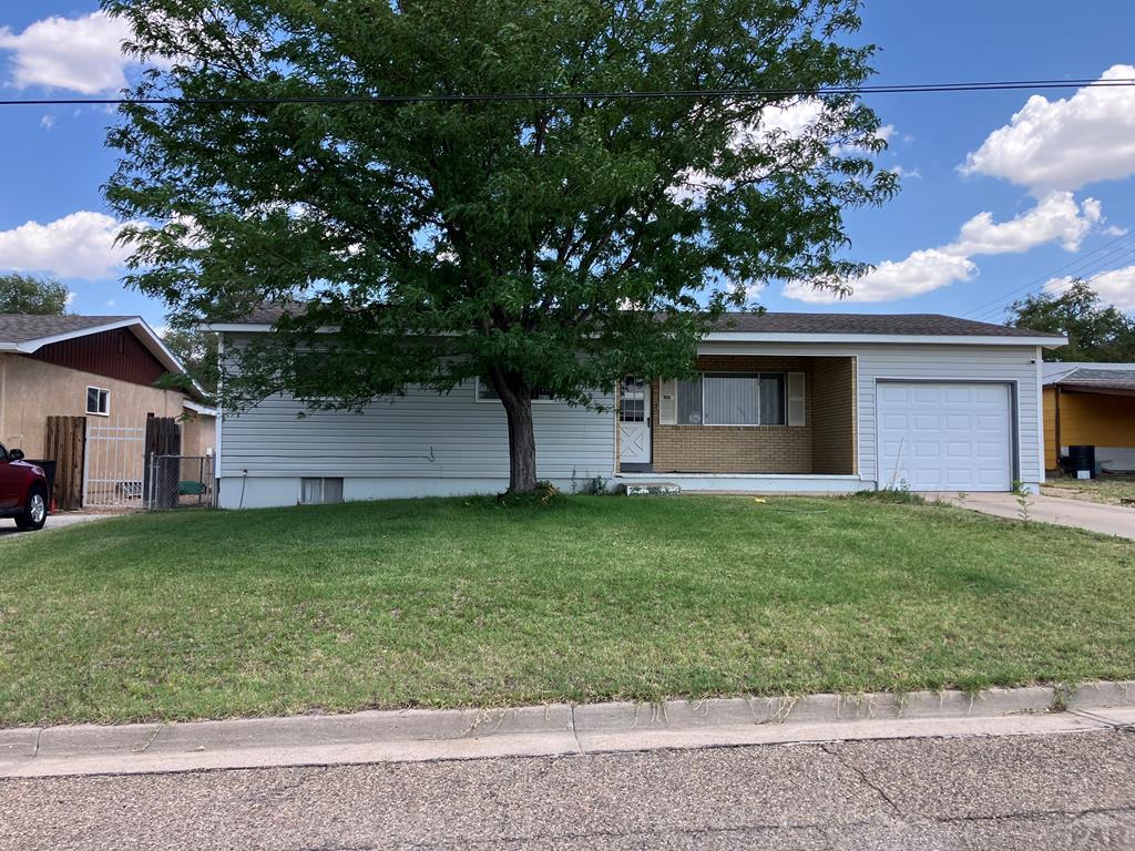 915 Maple Avenue La Junta, CO 81050 - Photo 2 of 34 a front view of house with a garden