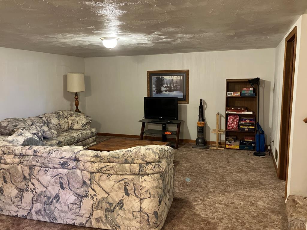 915 Maple Avenue La Junta, CO 81050 - Photo 24 of 34 a bedroom with a bed and a view of bedroom
