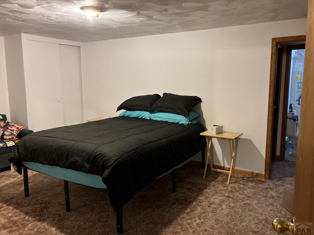 915 Maple Avenue La Junta, CO 81050 - Photo 28 of 34 a bedroom with a bed and chair