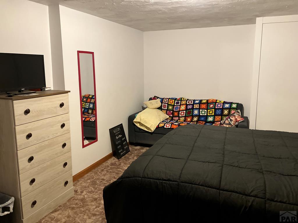915 Maple Avenue La Junta, CO 81050 - Photo 29 of 34 a bedroom with a bed and flat screen tv