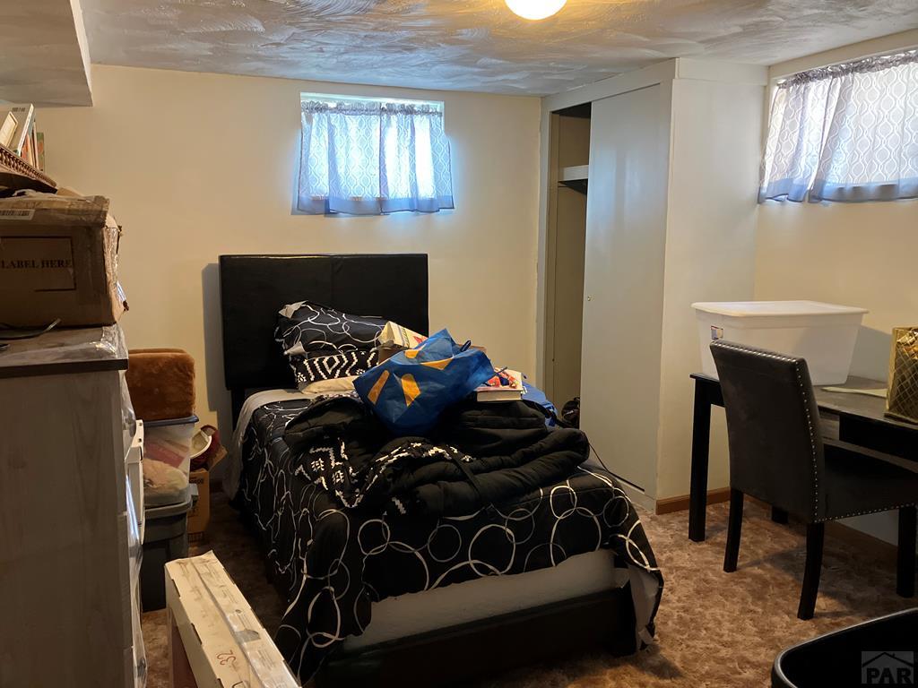 915 Maple Avenue La Junta, CO 81050 - Photo 30 of 34 a bedroom with a bed and a fireplace