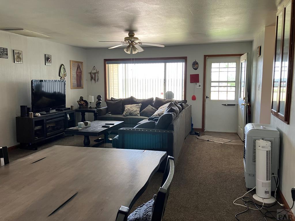 915 Maple Avenue La Junta, CO 81050 - Photo 3 of 34 a living room with furniture a window and a flat screen tv